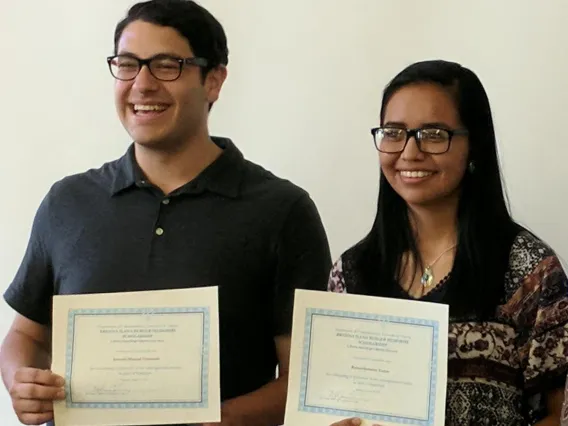 Students posing for a photo with their certificates.